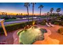 Inviting spa pool overlooks the lush golf course and community lake at sunset at 23116 N Del Monte Dr, Sun City West, AZ 85375