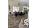 Inviting dining area showcases a modern chandelier, dining table with chairs, and access to the kitchen at 2634 E Fountain St, Mesa, AZ 85213