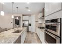 Well-lit kitchen with stainless steel appliances, granite countertops, and tile floors at 2753 S 85Th Way, Mesa, AZ 85209