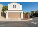A detached two-car garage with a light brown door and a well-maintained yard at 2918 N 48Th Pl, Phoenix, AZ 85018