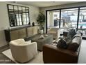 Bright living room with modern furniture, a large mirror, and sliding glass doors to the outdoor patio at 3016 N 49Th St, Phoenix, AZ 85018