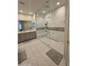 Bathroom featuring double sinks and a glass-enclosed shower with tile surround at 35317 N 31St Dr, Phoenix, AZ 85086