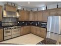 Modern kitchen featuring stainless steel appliances, granite countertops, and ample cabinet space at 35317 N 31St Dr, Phoenix, AZ 85086