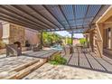 Luxurious backyard patio with a pergola, outdoor fireplace, and built-in grill, perfect for entertaining at 41624 N Anthem Ridge Dr, Anthem, AZ 85086