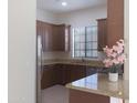 Kitchen boasts brown cabinets, granite countertops, stainless steel appliances and a window view at 4241 N Pebblecreek Pkwy # 54, Goodyear, AZ 85395