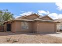 Exterior of a single-story home with well kept landscaping and a two-car garage at 4245 E Jason Dr, Phoenix, AZ 85050