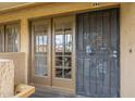 A close-up of a townhome entrance featuring double glass doors with decorative grids and a security door at 4901 S Calle Los Cerros Dr # 236, Tempe, AZ 85282