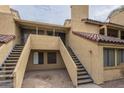 Southwest-style townhome featuring a private entrance with stairs leading to the unit's front door at 4901 S Calle Los Cerros Dr # 236, Tempe, AZ 85282