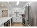 Well-lit kitchen with stainless steel appliances, subway tile backsplash, and quartz countertops at 5209 N 24Th St # 104, Phoenix, AZ 85016