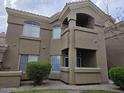 Exterior view of the condo building showing balconies, tan stucco facade and updated windows at 5335 E Shea Blvd # 1035, Scottsdale, AZ 85254