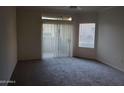 Open living room with neutral paint and plush carpet with large glass sliding door to an outdoor space at 5335 E Shea Blvd # 1035, Scottsdale, AZ 85254