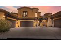 Mediterranean-style home featuring a three-car garage, gated entry and lush greenery at 5370 S Desert Dawn Dr # 50, Gold Canyon, AZ 85118