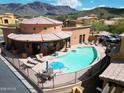 Community pool and spa area with lounge chairs and mountain views at 5370 S Desert Dawn Dr # 50, Gold Canyon, AZ 85118