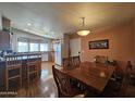 Dining room showcasing wood table and chairs adjacent to the kitchen area at 650 N Hawes Rd # 4406, Mesa, AZ 85207