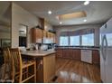 Bright kitchen with wood floors, island, and ample counter space and cabinets at 650 N Hawes Rd # 4406, Mesa, AZ 85207