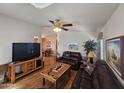 Cozy living room featuring hardwood floors, ceiling fan, and comfortable leather furniture at 650 N Hawes Rd # 4406, Mesa, AZ 85207