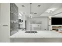 This kitchen features a large island with a sink, black and white backsplash and stainless steel appliances at 7151 E Rancho Vista Dr # 1003, Scottsdale, AZ 85251