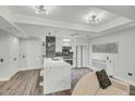 The modern kitchen features an island with seating and a black and white backsplash that opens to the living room at 7151 E Rancho Vista Dr # 1003, Scottsdale, AZ 85251