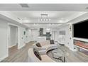 Bright living room featuring modern lighting, fireplace, television and an open floorplan flowing into the kitchen at 7151 E Rancho Vista Dr # 1003, Scottsdale, AZ 85251