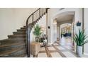 Elegant foyer with a staircase, stylish flooring, and contemporary decor at 7424 E Sandia Cir, Mesa, AZ 85207