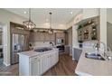 Modern kitchen featuring stainless steel appliances, stone countertops and gray cabinets at 7424 E Sandia Cir, Mesa, AZ 85207
