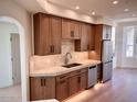 This modern kitchen features wood cabinets, stainless steel appliances, and marble countertops at 7955 E Chaparral Rd # 34, Scottsdale, AZ 85250