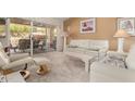 Cozy living room with white furniture and access to the outdoor patio at 8850 W Piute Ave, Peoria, AZ 85382