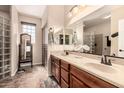 Bathroom features double sinks, wooden cabinets, and a privacy window at 11062 E Ocaso Ave, Mesa, AZ 85212