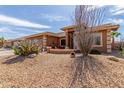 Attractive single-story home featuring desert landscaping and a charming front porch at 11121 E Onza Ave, Mesa, AZ 85212