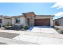 Charming single-story home featuring stone accents, a two-car garage, and low maintenance desert landscaping at 17893 W Indigo Brush Rd, Goodyear, AZ 85338