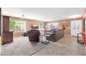 Bright living room featuring tile and carpet flooring, with large windows offering plenty of natural light at 20615 N 55Th Ave, Glendale, AZ 85308