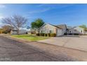 Property showing an expansive driveway and well-maintained landscaping, with multiple garage spaces at 21735 S 140Th St, Chandler, AZ 85286