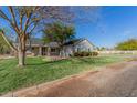 Lovely home with a spacious front yard and a charming white fence along the property line at 21735 S 140Th St, Chandler, AZ 85286