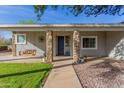 Inviting front porch with stone pillars and a wooden porch swing, perfect for relaxing outdoors at 21735 S 140Th St, Chandler, AZ 85286