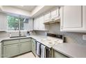 Well-lit kitchen with stainless steel sink, ample counter space, and plentiful cabinet storage at 2338 W Lindner Ave # 22, Mesa, AZ 85202