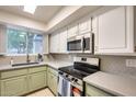 Bright kitchen featuring modern stainless steel appliances, stone countertops, and stylish backsplash at 2338 W Lindner Ave # 22, Mesa, AZ 85202