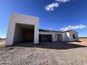 A modern stucco home is under construction with a three-car garage at 31114 W 213Th Ln, Wittmann, AZ 85361