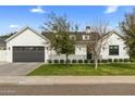 Charming home featuring a manicured lawn, a modern architectural style, and a two-car garage at 3808 E Fairmount Ave, Phoenix, AZ 85018