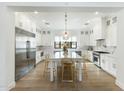 Spacious kitchen featuring a large island with seating, stainless steel appliances, and custom white cabinetry at 3808 E Fairmount Ave, Phoenix, AZ 85018