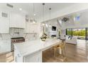 Open-concept kitchen showcasing a large quartz island, stainless steel appliances, and a view into the stylish living room at 3808 E Fairmount Ave, Phoenix, AZ 85018