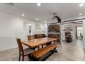 Dining room with large table, bench seating, and decorative barn door to the living room at 3923 S Dorsey Ln, Tempe, AZ 85282