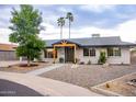 Charming home exterior featuring manicured landscaping, decorative rock, and covered entryway at 3923 S Dorsey Ln, Tempe, AZ 85282