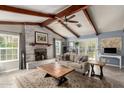 Cozy living room with exposed beam ceiling, fireplace, neutral color palette, and natural light at 3923 S Dorsey Ln, Tempe, AZ 85282