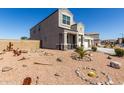 Beautiful home featuring a three-car garage and desert landscaping in the front yard at 3932 N 306Th Ln, Buckeye, AZ 85396