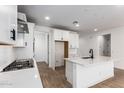 Bright kitchen with white cabinets, subway tile backsplash and stainless steel appliances at 40546 W Michaels Dr, Maricopa, AZ 85138
