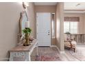 Inviting foyer featuring a decorative mirror, elegant table, and stylish flooring at 4241 N Pebble Creek Pkwy # 28, Goodyear, AZ 85395