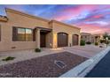 Beautiful home showcasing desert landscaping, a spacious three car garage, and an inviting front entrance at 4241 N Pebble Creek Pkwy # 28, Goodyear, AZ 85395