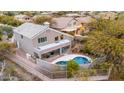 Aerial view of a private backyard featuring a pool, patio, and mature landscaping for outdoor enjoyment at 4801 E Quien Sabe Way, Cave Creek, AZ 85331