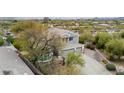 Two-story home showcasing desert landscaping, an attached two-car garage, and a neutral color scheme at 4801 E Quien Sabe Way, Cave Creek, AZ 85331