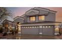 Frontal view of a two-car attached garage featuring stylish doors and manicured landscaping at 4801 E Quien Sabe Way, Cave Creek, AZ 85331